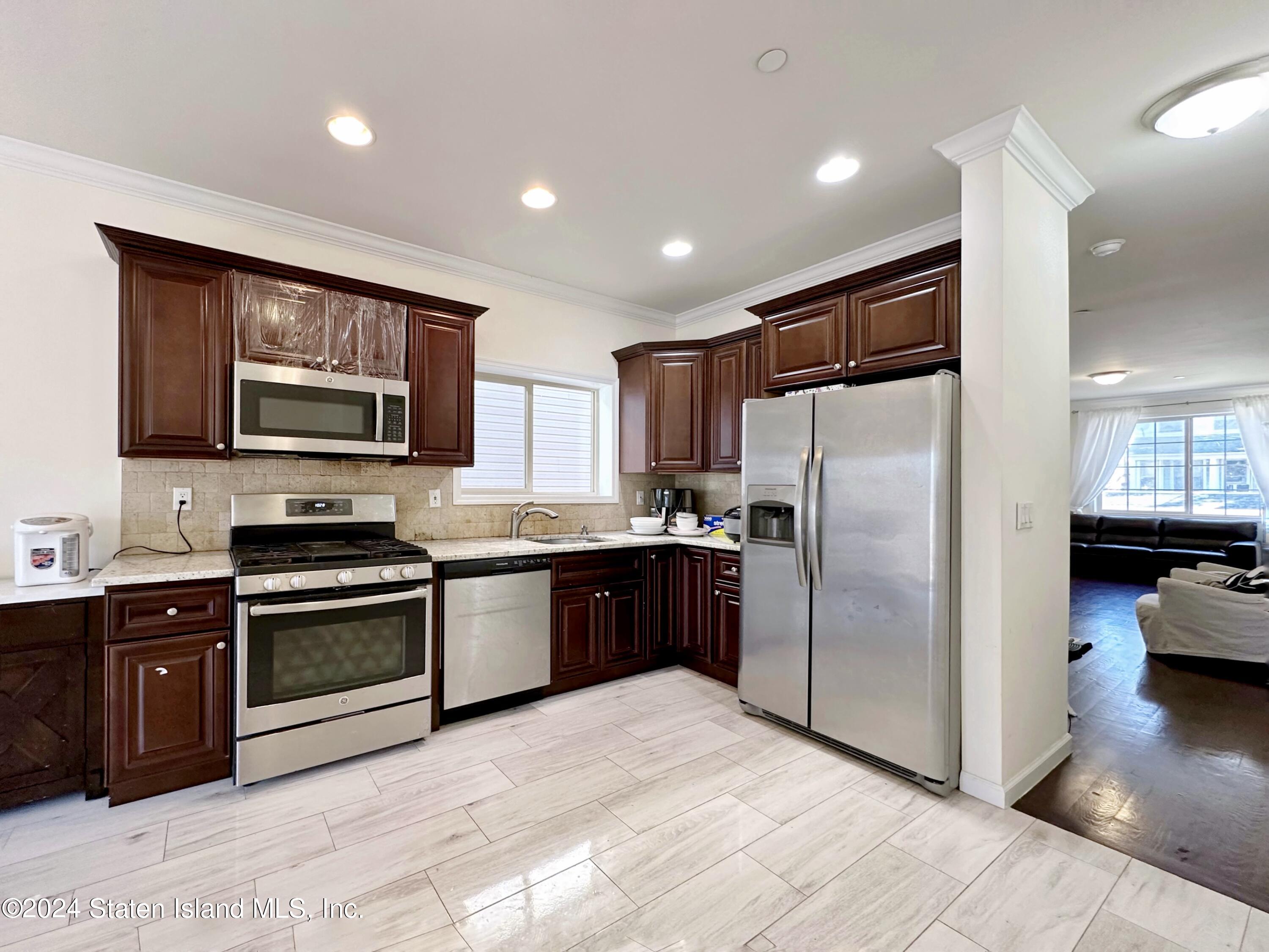94 Catherine Street Staten Island, NY 10302 - Photo 15 of 33 a kitchen with stainless steel appliances granite countertop a refrigerator stove and sink