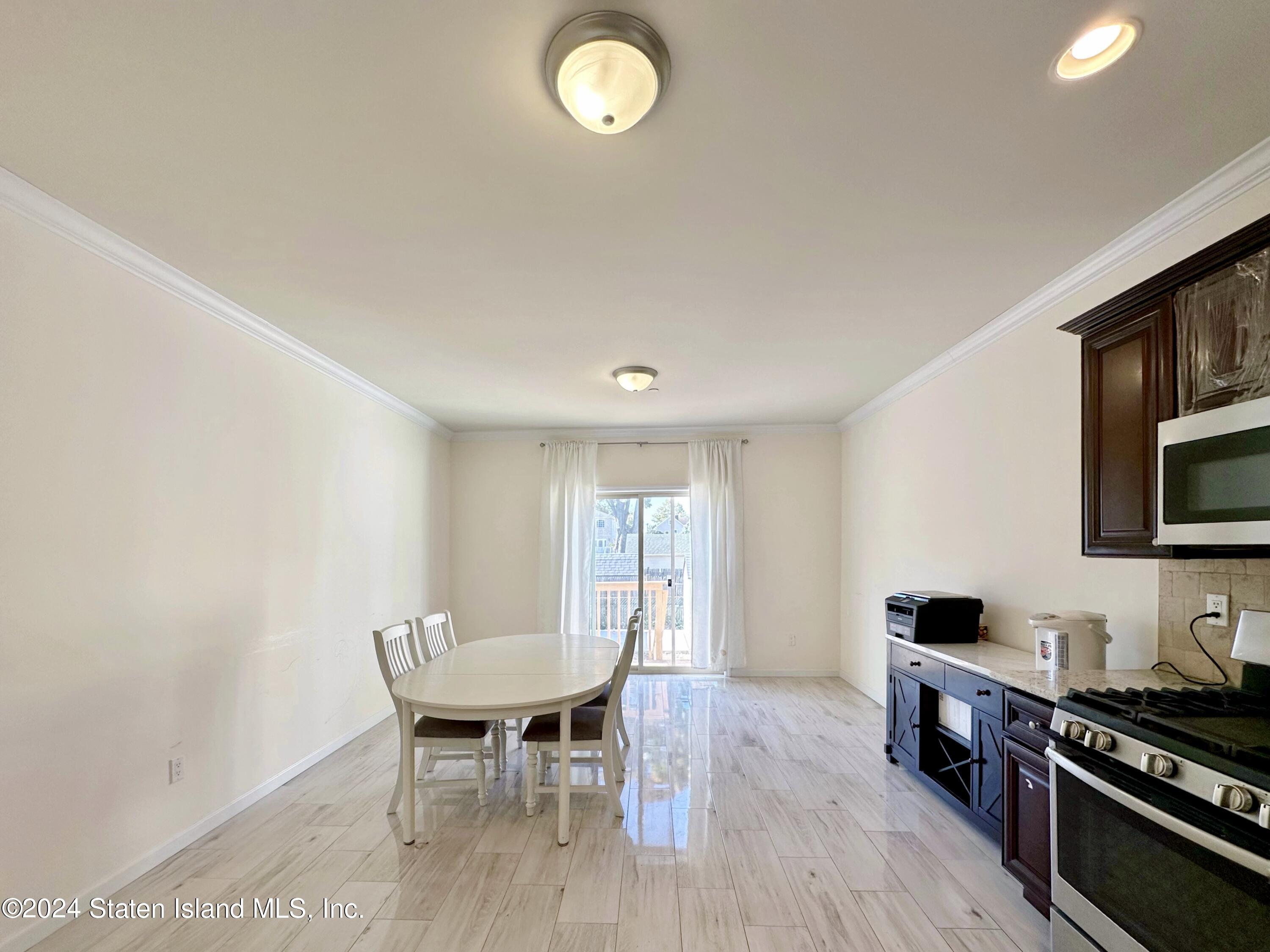 94 Catherine Street Staten Island, NY 10302 - Photo 16 of 33 a view of a dining room with furniture and wooden floor