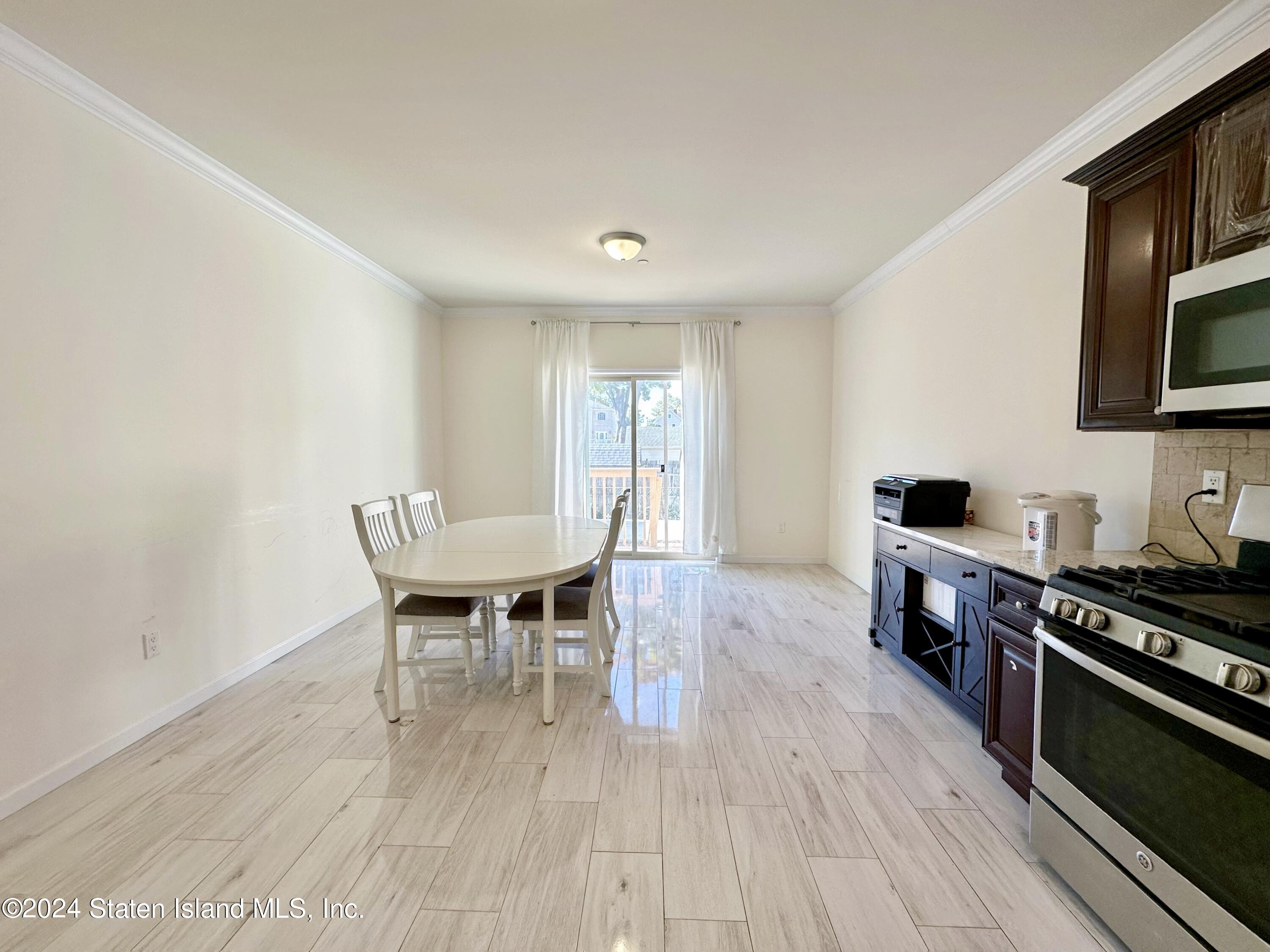 94 Catherine Street Staten Island, NY 10302 - Photo 20 of 33 a dining room with furniture and wooden floor