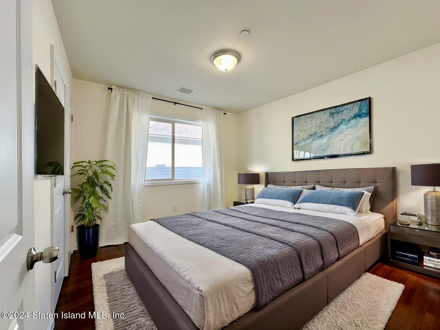 94 Catherine Street Staten Island, NY 10302 - Photo 25 of 33 a bedroom with bed and a potted plant