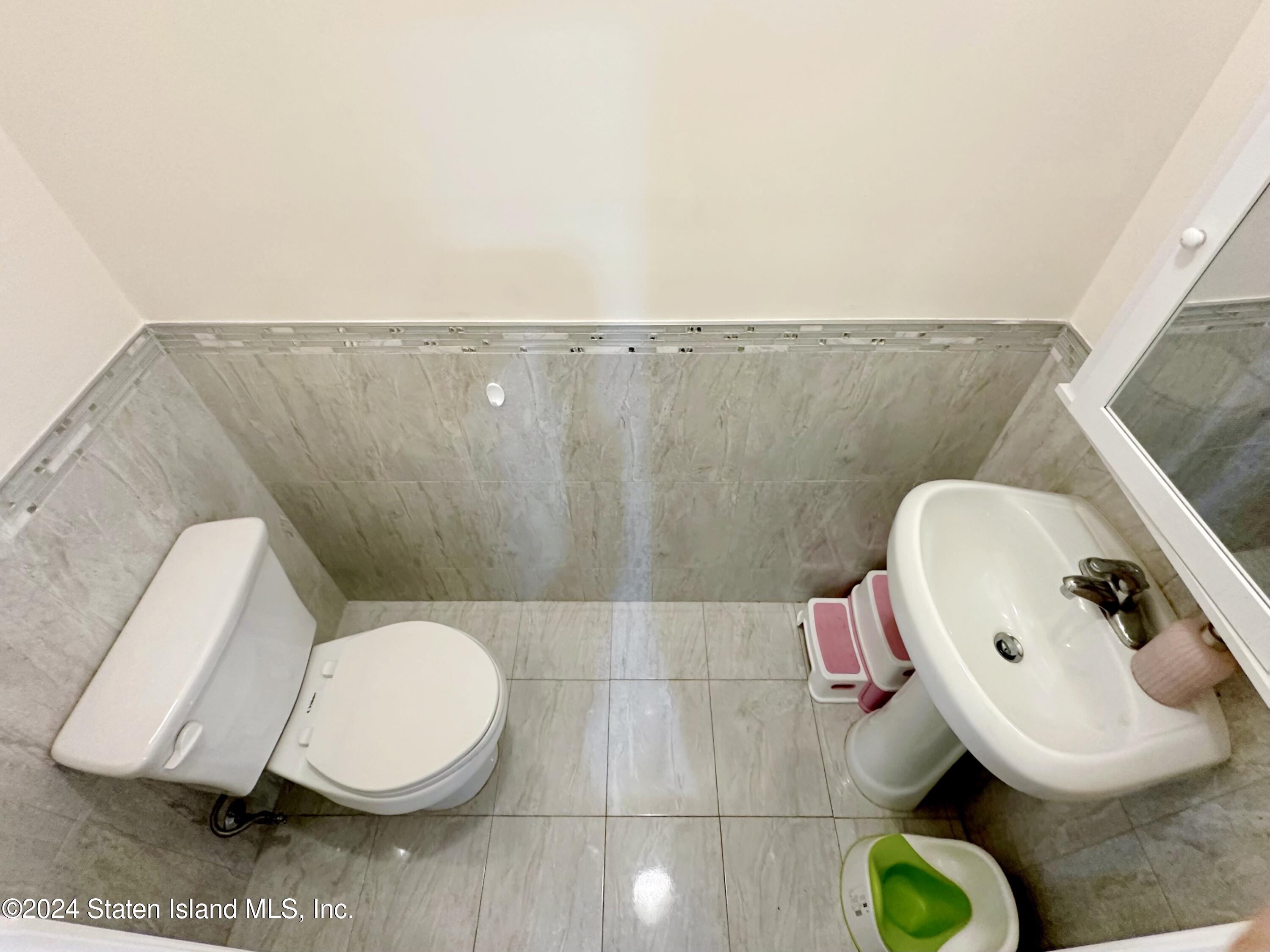 94 Catherine Street Staten Island, NY 10302 - Photo 30 of 33 a bathroom with a toilet and a mirror