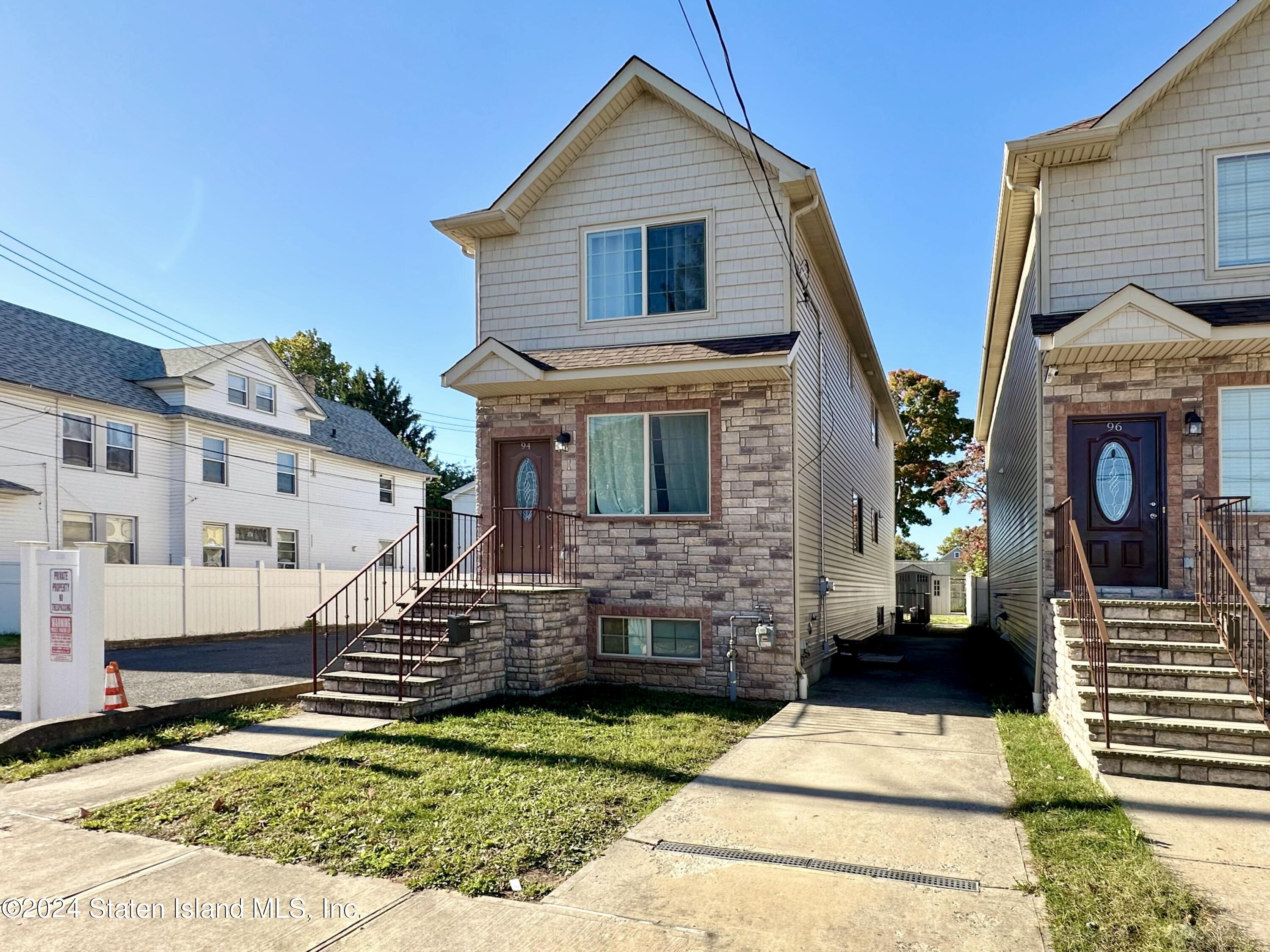 94 Catherine Street Staten Island, NY 10302 - Photo 3 of 33 a front view of a house with a yard