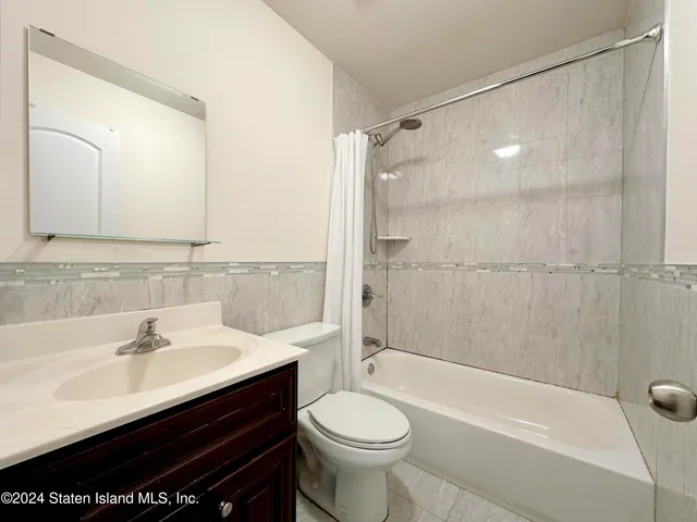 a bathroom with a sink mirror toilet and bathtub