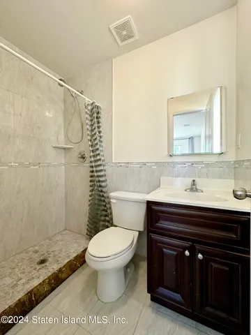 a bathroom with a sink a toilet and a shower