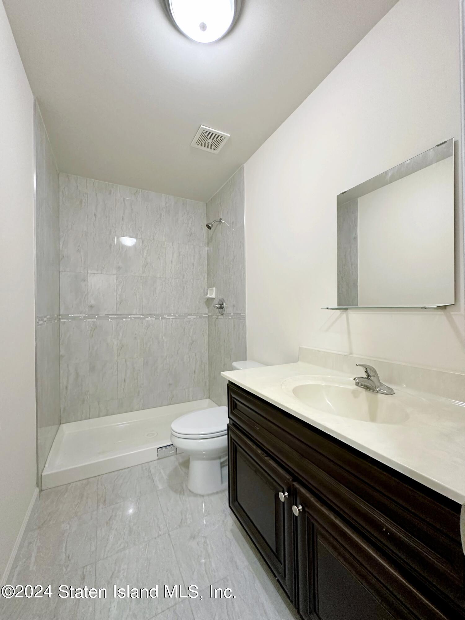 94 Catherine Street Staten Island, NY 10302 - Photo 33 of 33 a bathroom with a sink a toilet and shower