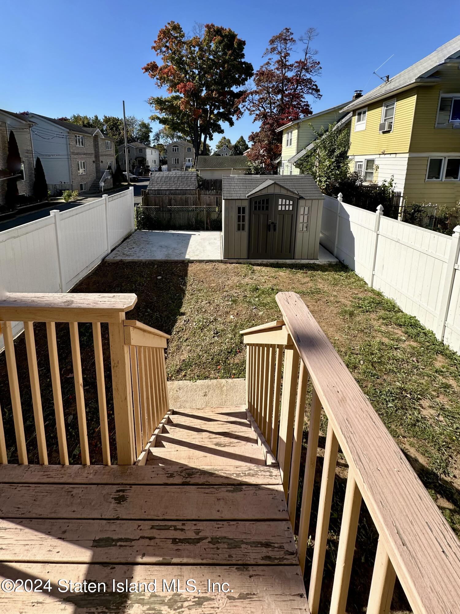 94 Catherine Street Staten Island, NY 10302 - Photo 7 of 33 a view of a balcony with wooden floor and potted plants