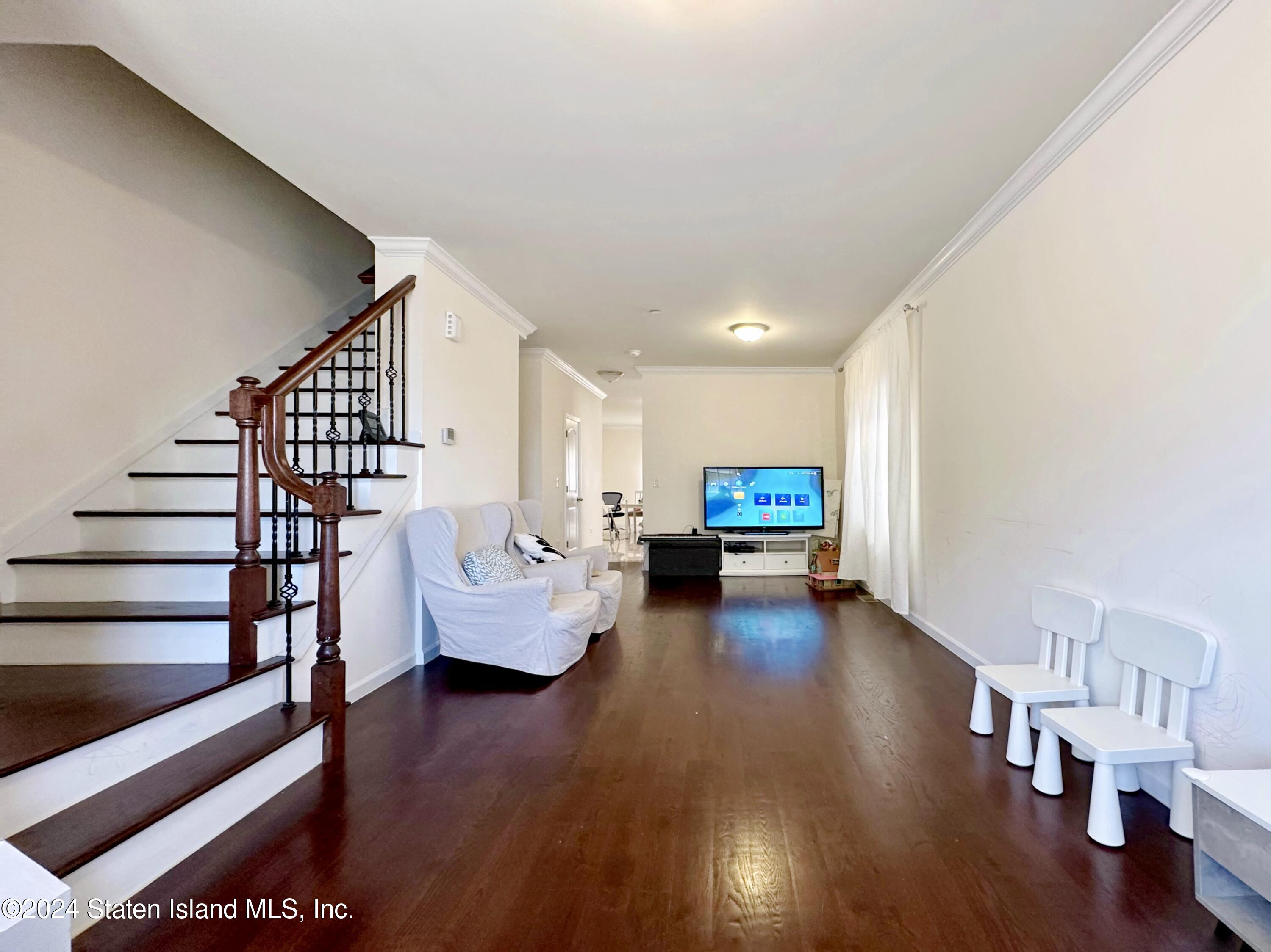 94 Catherine Street Staten Island, NY 10302 - Photo 8 of 33 a living room with furniture and a wooden floor
