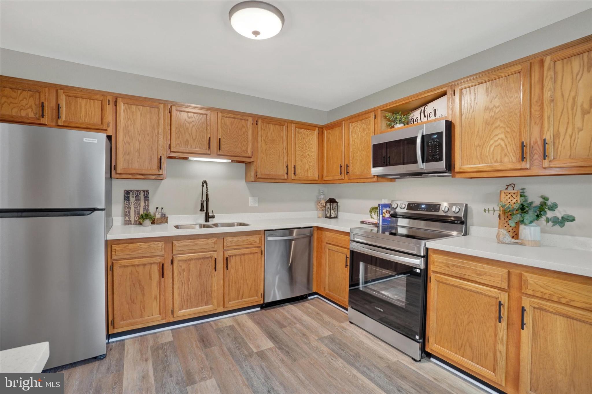 1606 Condor Lane Dover, PA 17315 - Photo 4 of 28 a kitchen with granite countertop wooden cabinets stainless steel appliances and a window