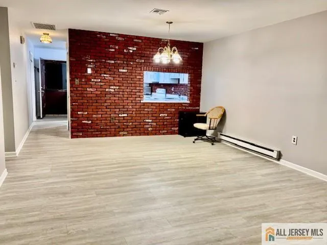 a view of a livingroom with furniture and chandelier fan