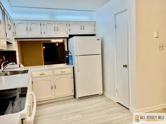 a view of a kitchen with electric appliances