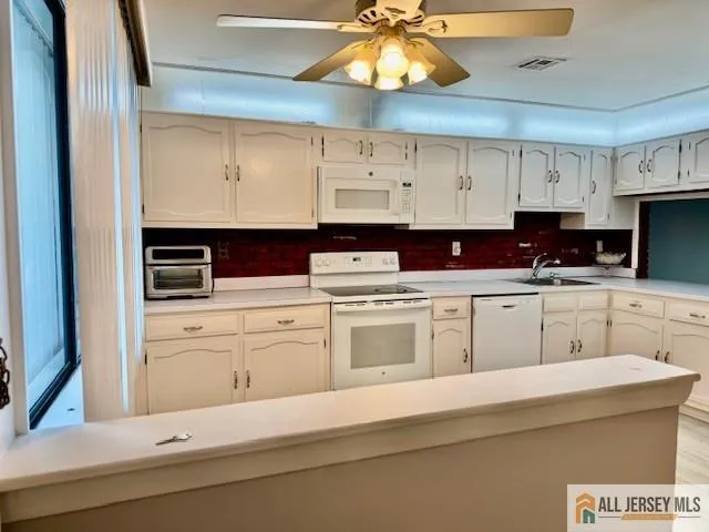 a kitchen with stainless steel appliances white cabinets and a sink