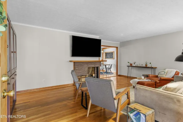a living room with furniture a fireplace and a flat screen tv