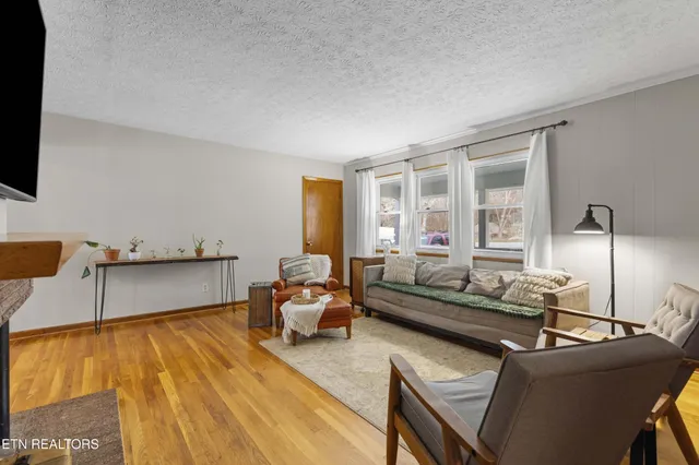 a front view of a house with a garden and yard