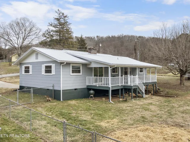 a view of a yard with a house in the background