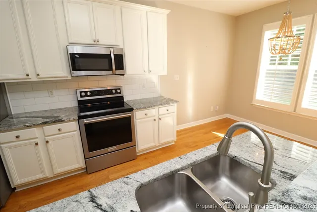 a spacious bathroom with a granite countertop sink and a mirror