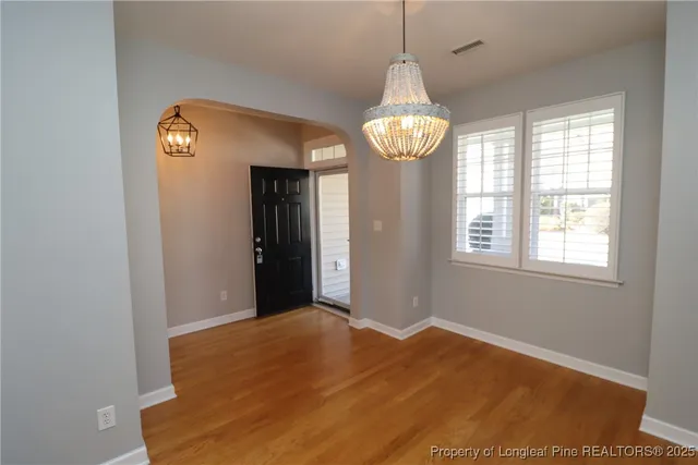 a view of an empty room with a window and a fireplace