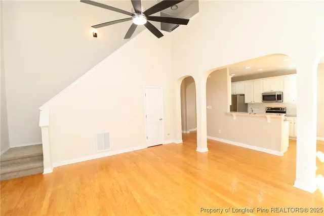 a view of empty room with ceiling fan