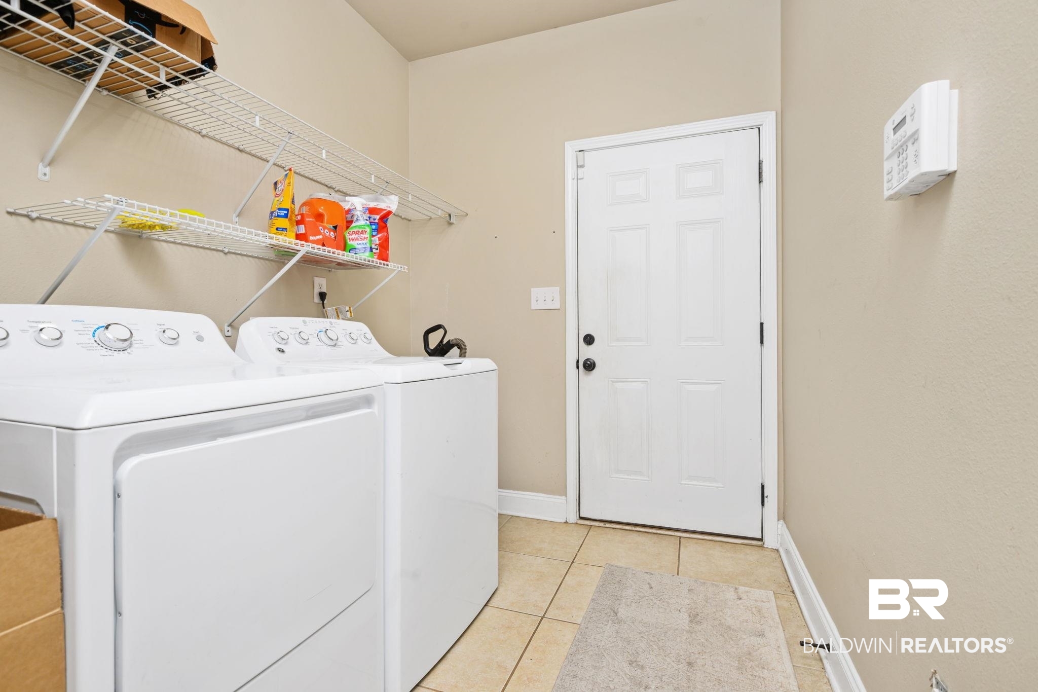7506 Carlson Court Mobile, AL 36619 - Photo 21 of 33 Laundry room with light tile patterned floors and washer and dryer