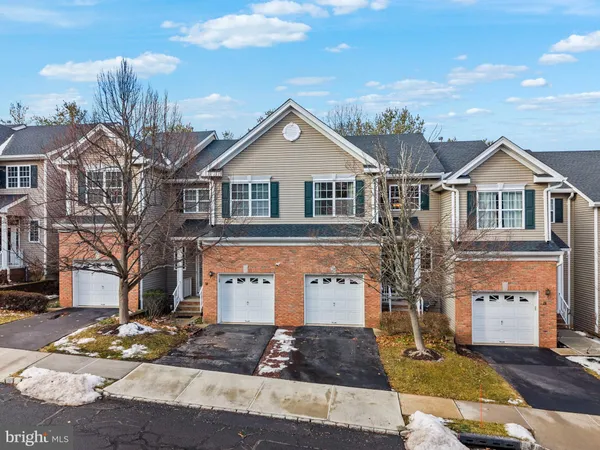 a front view of a house with trees