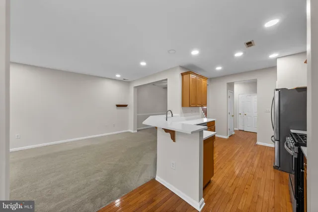 a view of kitchen with refrigerator microwave and cabinets