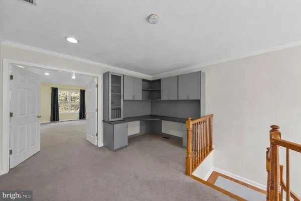 a view of kitchen with refrigerator and wooden floor