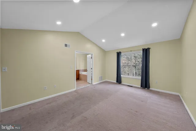a view of a livingroom with an empty space and a window