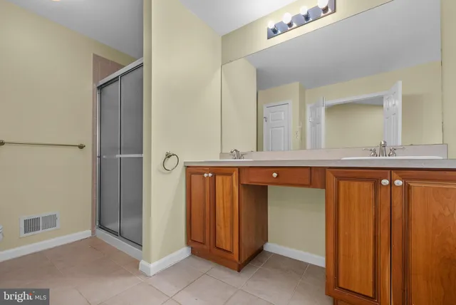a bathroom with a tub a sink and mirror