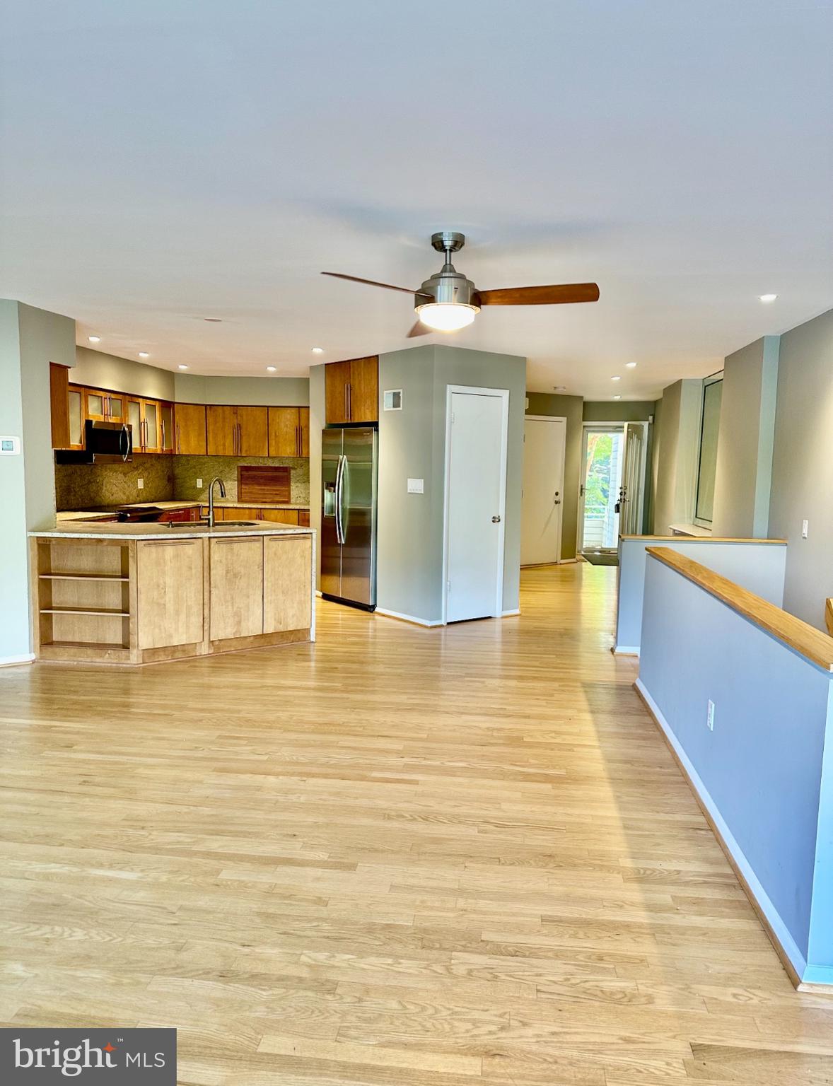 1969 Lakeport Way Reston, VA 20191 - Photo 3 of 11 a view of a living room with kitchen island stainless steel appliances wooden floor and furniture