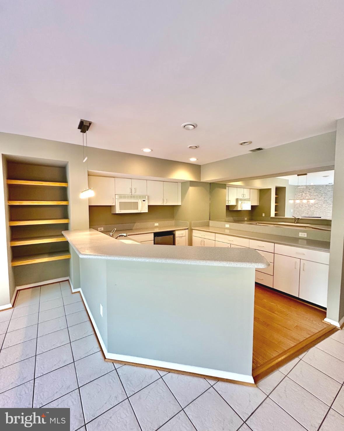 1969 Lakeport Way Reston, VA 20191 - Photo 9 of 11 a living room with stainless steel appliances kitchen island granite countertop a sink and cabinets