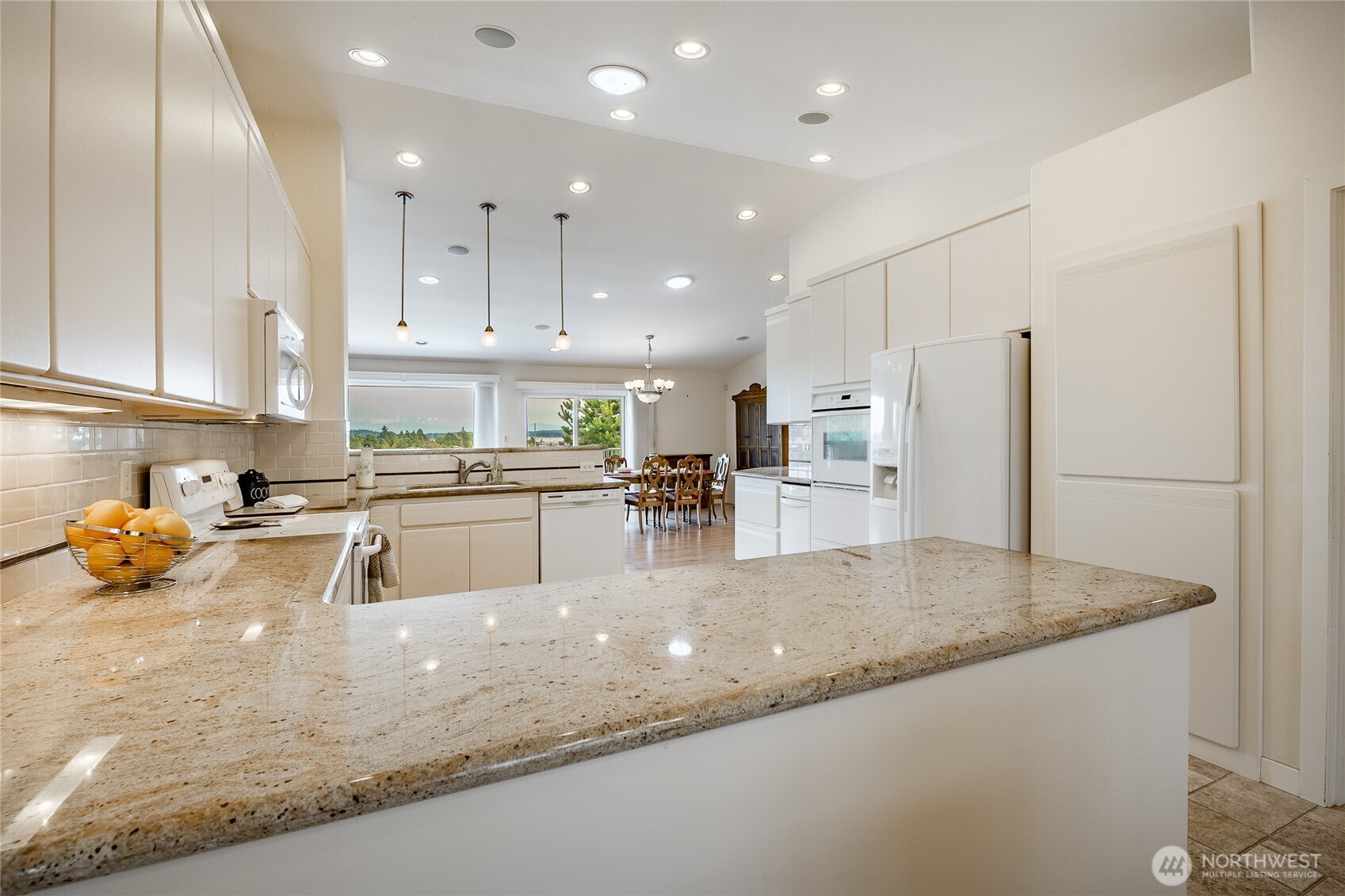 8118 Comox Road Blaine, WA 98230 - Photo 11 of 40 a kitchen with stainless steel appliances granite countertop a sink refrigerator and cabinets