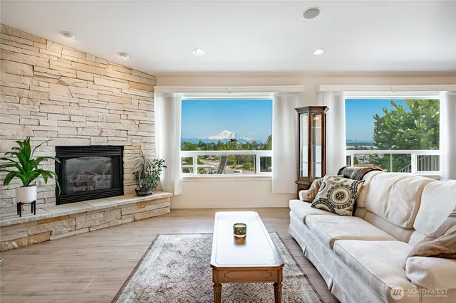 a spacious bedroom with a bed a table and large windows