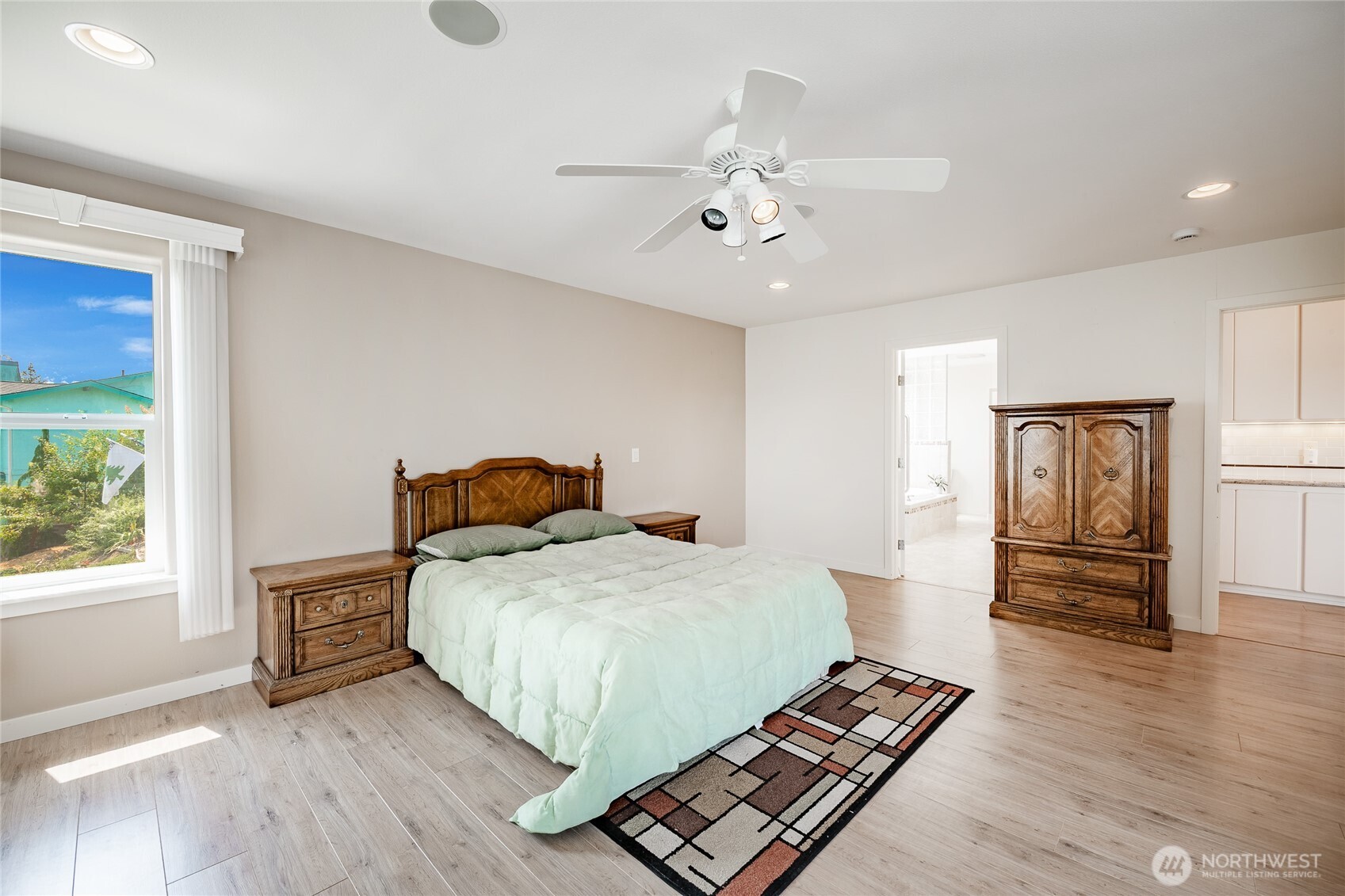 8118 Comox Road Blaine, WA 98230 - Photo 21 of 40 a bedroom with a bed and wooden floor