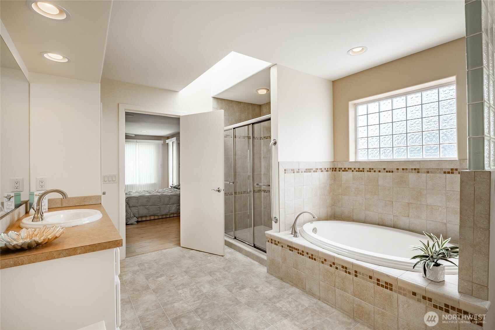 8118 Comox Road Blaine, WA 98230 - Photo 23 of 40 a bathroom with a granite countertop tub sink and mirror