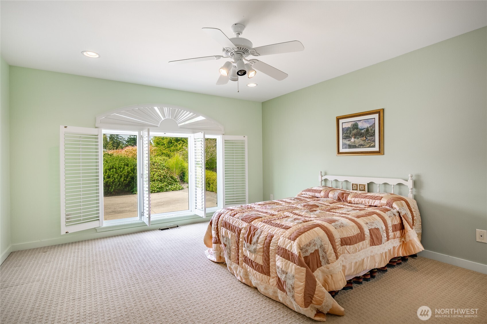 8118 Comox Road Blaine, WA 98230 - Photo 25 of 40 a bedroom with a large bed and a large window