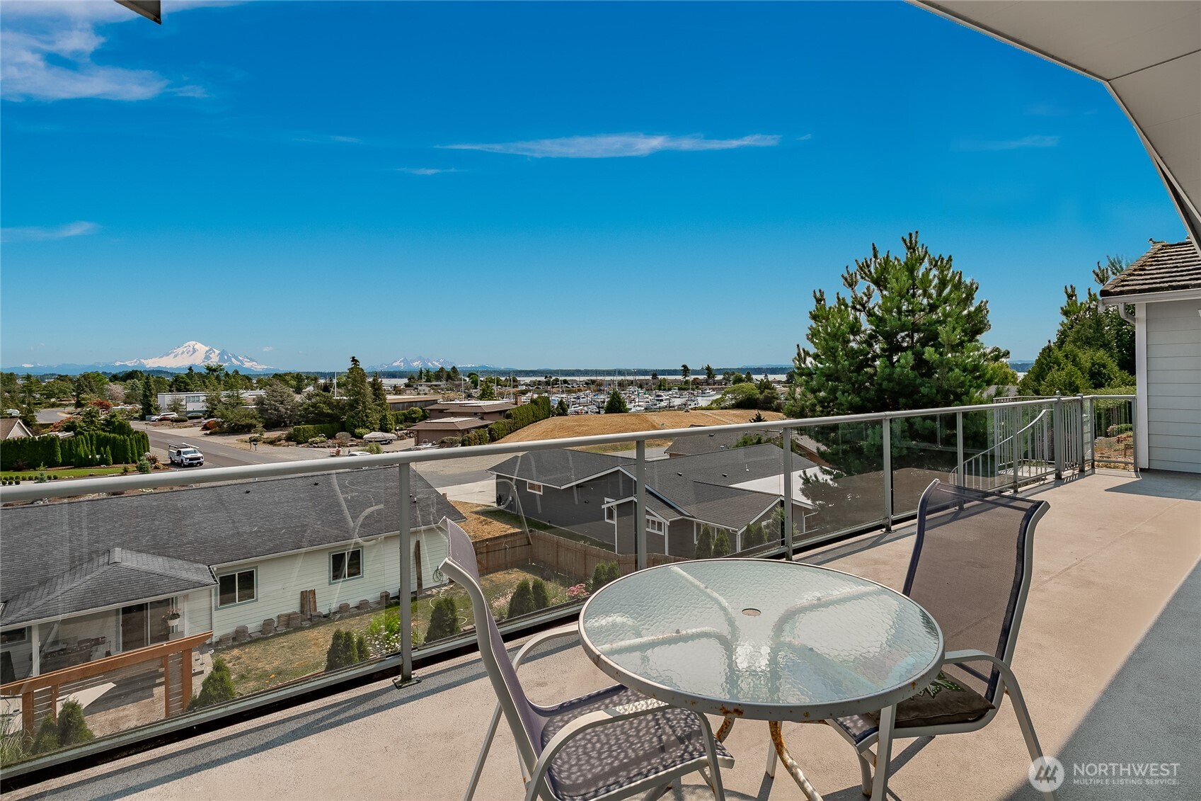 8118 Comox Road Blaine, WA 98230 - Photo 31 of 40 a balcony with table and chairs