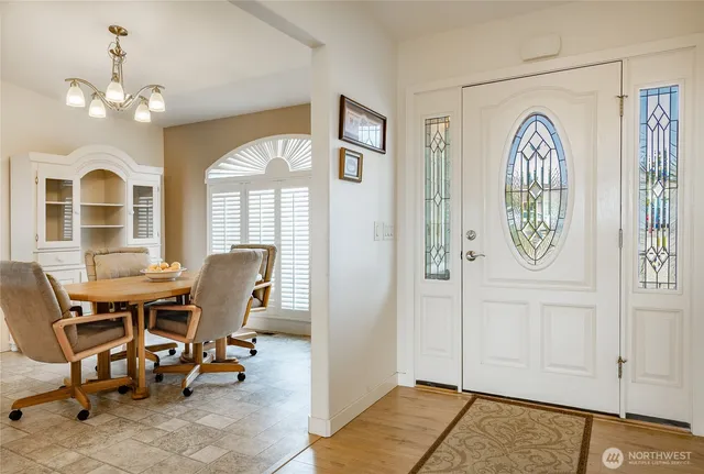 a view of a livingroom with workspace and a window