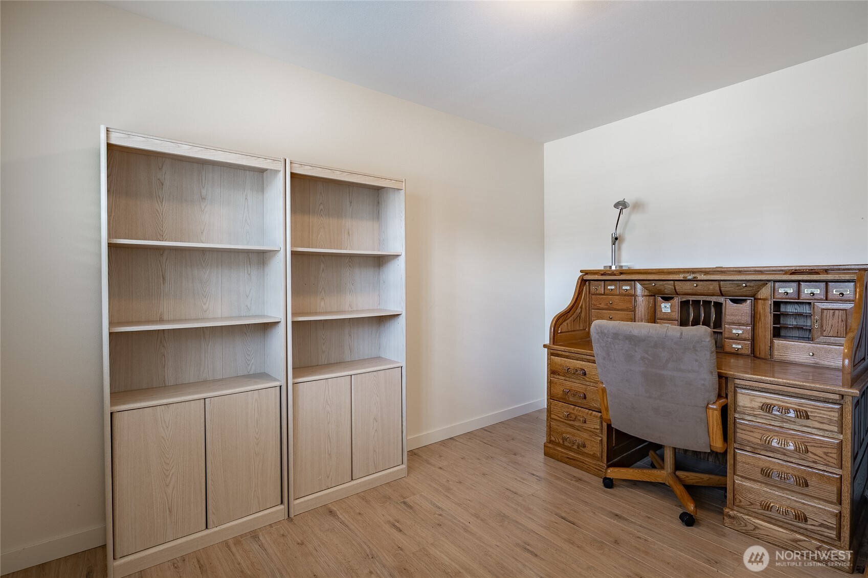 8118 Comox Road Blaine, WA 98230 - Photo 8 of 40 a view of a workspace with furniture and wooden floor