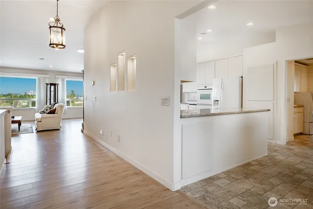 a view of a kitchen with furniture and wooden floor