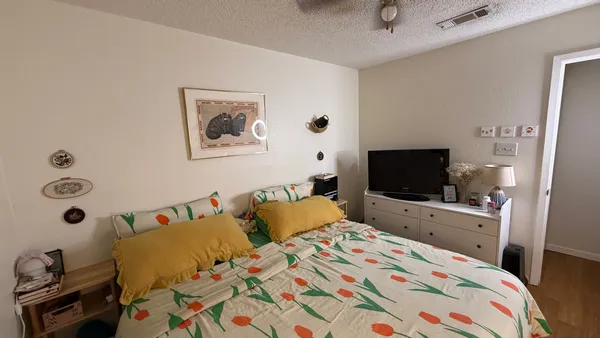 a bedroom with a bed and a flat screen tv