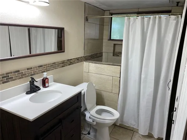 a kitchen with granite countertop white cabinets and a sink