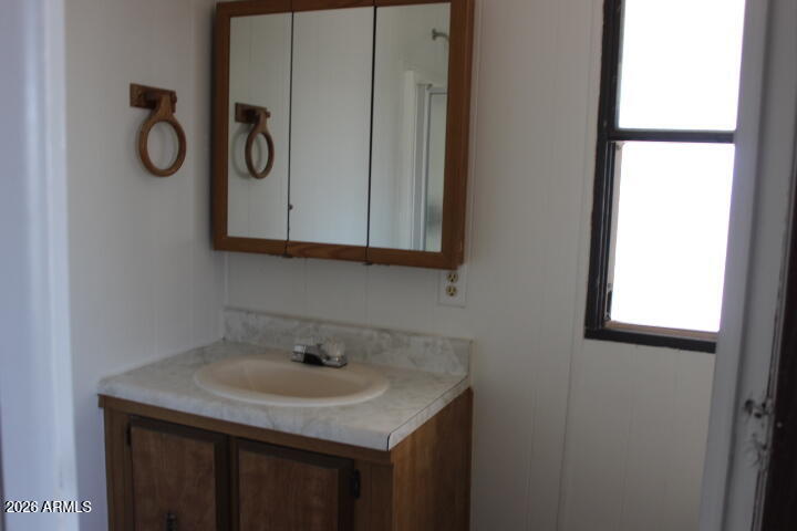 303 South Recker Road, Unit 128 Mesa, AZ 85206 - Photo 13 of 26 a bathroom with a sink and a mirror