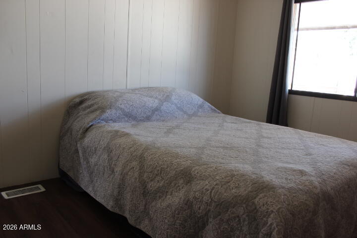 303 South Recker Road, Unit 128 Mesa, AZ 85206 - Photo 20 of 26 a bed sitting in a bedroom next to a window