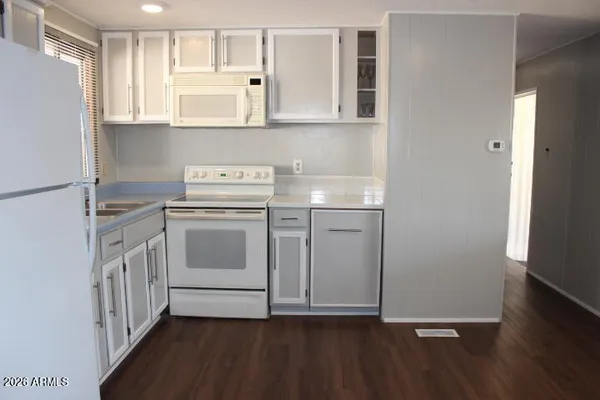 a kitchen with a refrigerator and a sink