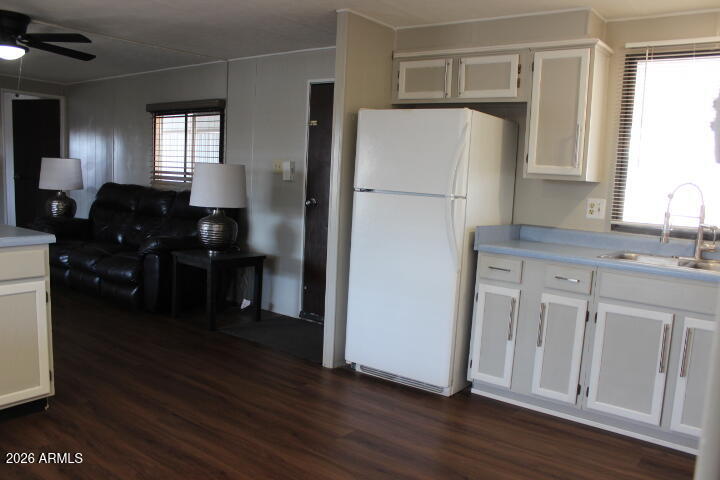 303 South Recker Road, Unit 128 Mesa, AZ 85206 - Photo 7 of 26 a kitchen with a refrigerator and a sink