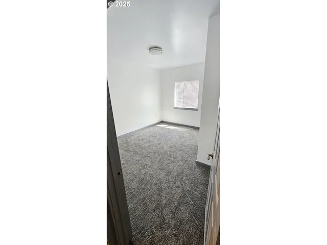 a view of a hallway with toilet and a entryway