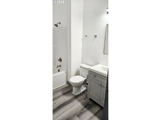 a view of a house with a wooden fence