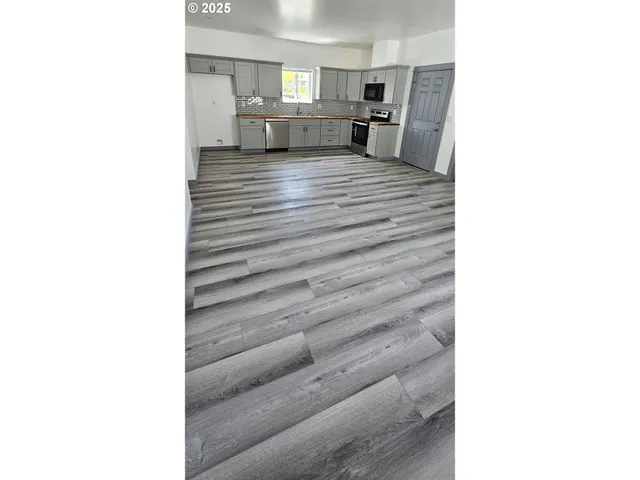 a view of a living room with a furniture and a refrigerator