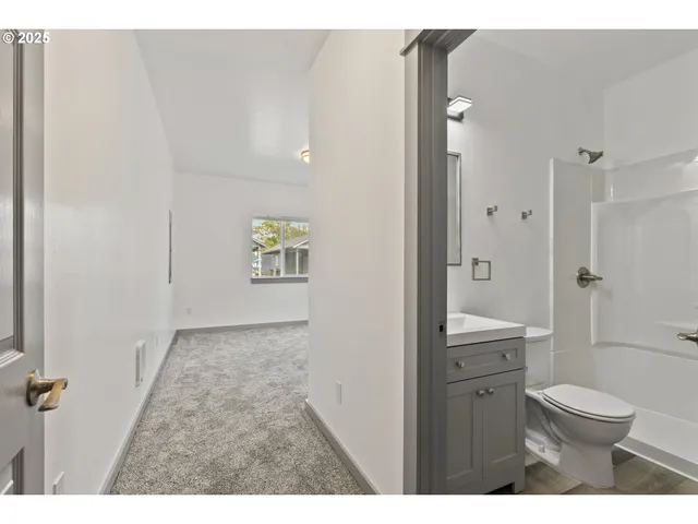 a bathroom with a sink a toilet a shower and a mirror