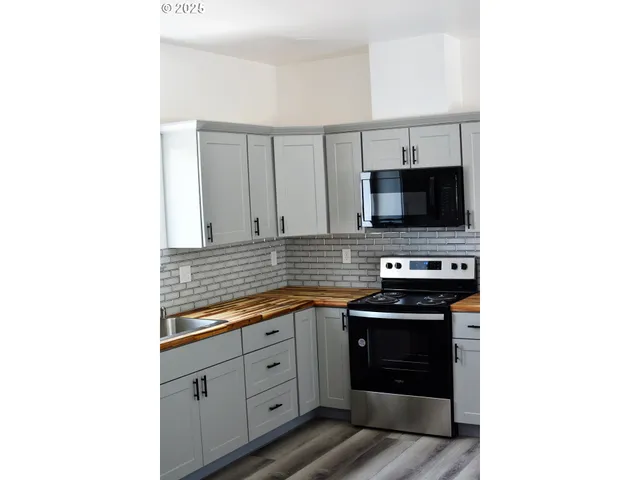 a kitchen with a sink and a stove top oven