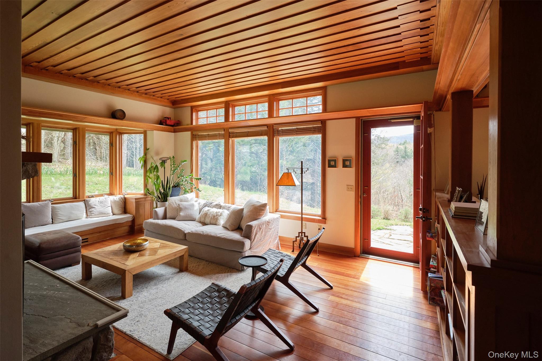 74 High Meadow Road Livingston Manor, NY 12758 - Photo 3 of 41 a living room with furniture a wooden floor and next to a large window